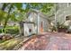 Rear view of the house showcasing a brick patio, storage shed, and lush greenery at 2034 Lanier Ave, Charlotte, NC 28205