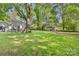 The expansive backyard includes patio, sheds, playhouse, and large trees at 2034 Lanier Ave, Charlotte, NC 28205