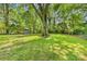 Expansive backyard with mature trees, providing ample shade and a charming playhouse at 2034 Lanier Ave, Charlotte, NC 28205