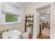 Bright bathroom with a toilet, ladder shelf for storage, and a window providing plenty of natural light at 2034 Lanier Ave, Charlotte, NC 28205