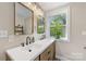 Contemporary bathroom featuring double sink vanity and lots of light from an exterior window at 2034 Lanier Ave, Charlotte, NC 28205