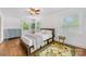 Charming bedroom with hardwood floors, two windows providing natural light, and stylish decor at 2034 Lanier Ave, Charlotte, NC 28205