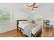 Spacious bedroom with hardwood floors, natural light, and a bed with storage underneath, creating a relaxing retreat at 2034 Lanier Ave, Charlotte, NC 28205