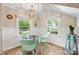 Bright dining area features a beaded chandelier, herringbone floors, and many windows with outside views at 2034 Lanier Ave, Charlotte, NC 28205
