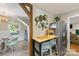 Bright dining area features a modern chandelier, herringbone floors, and adjacent to the kitchen at 2034 Lanier Ave, Charlotte, NC 28205