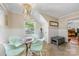 Bright dining area features a beaded chandelier, herringbone floors, and entry to a hallway at 2034 Lanier Ave, Charlotte, NC 28205