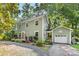 Charming two-story home boasts a quaint fenced yard, inviting entrance, and attached garage at 2034 Lanier Ave, Charlotte, NC 28205