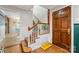 Foyer features a staircase with patterned tiles and an original hardwood door at 2034 Lanier Ave, Charlotte, NC 28205