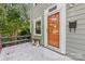 Inviting front porch with a charming wooden bench next to the stylish front door and mailbox at 2034 Lanier Ave, Charlotte, NC 28205