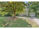 Spacious front yard featuring a mature tree providing ample shade to this charming home at 2034 Lanier Ave, Charlotte, NC 28205