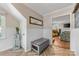 Hallway featuring herringbone floors and entry to a living room with adjacent dining area at 2034 Lanier Ave, Charlotte, NC 28205