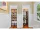Bright hallway with built-in storage shelves and an abundance of natural light from the window at 2034 Lanier Ave, Charlotte, NC 28205