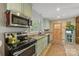 Bright kitchen featuring stainless steel appliances, granite countertops, and wood flooring at 2034 Lanier Ave, Charlotte, NC 28205