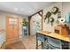 Kitchen featuring herringbone floors, wooden beam, breakfast bar, and salmon colored door at 2034 Lanier Ave, Charlotte, NC 28205