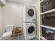 Practical laundry room with stacked washer/dryer, storage shelves, and eye-catching patterned flooring at 2034 Lanier Ave, Charlotte, NC 28205
