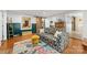 Spacious living room showcasing hardwood floors, unique rug, and an open layout to the kitchen at 2034 Lanier Ave, Charlotte, NC 28205