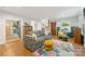 Cozy living room with hardwood floors, decorative fireplace, and an open floor plan at 2034 Lanier Ave, Charlotte, NC 28205