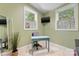Cozy office space with large windows, natural light, and custom green walls at 2034 Lanier Ave, Charlotte, NC 28205
