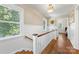 Bright stairwell featuring hardwood floors and wainscotting and light from a large window at 2034 Lanier Ave, Charlotte, NC 28205