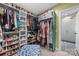 Organized walk-in closet with shelves and an ensuite bathroom featuring a patterned floor at 2034 Lanier Ave, Charlotte, NC 28205