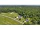 Aerial showcases a house with a pool and outbuilding, nestled in a lush, green landscape at 247 Helton Rd, Cherryville, NC 28021