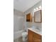 Full bathroom featuring a shower-tub combo, oak vanity, and a mirrored medicine cabinet at 247 Helton Rd, Cherryville, NC 28021