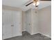 Neutral bedroom featuring a double closet, fan with light fixture, and gray carpet at 247 Helton Rd, Cherryville, NC 28021