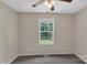Cozy bedroom with neutral walls, carpet flooring, and a window overlooking the front yard at 247 Helton Rd, Cherryville, NC 28021