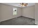Cozy bedroom with neutral walls, carpet flooring, and a window for natural light at 247 Helton Rd, Cherryville, NC 28021