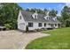 Charming two-story home features a front-facing garage, covered porch, and manicured lawn at 247 Helton Rd, Cherryville, NC 28021