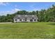 Expansive front yard featuring a well-maintained lawn, mature trees, and a charming single-Gathering home at 247 Helton Rd, Cherryville, NC 28021