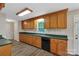 Charming kitchen featuring wood cabinets, green countertops, and a window overlooking the backyard at 247 Helton Rd, Cherryville, NC 28021