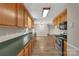 An elongated kitchen includes stainless steel appliances and lots of cabinet space with wood flooring at 247 Helton Rd, Cherryville, NC 28021