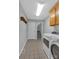 Laundry room with a washer and dryer, tile flooring, and oak cabinets at 247 Helton Rd, Cherryville, NC 28021