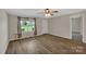 Inviting living room with neutral paint, a window overlooking the front yard, and vinyl wood floors at 247 Helton Rd, Cherryville, NC 28021
