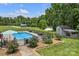 Aerial view of the fenced-in in-ground swimming pool, shed, and mature landscaping at 247 Helton Rd, Cherryville, NC 28021