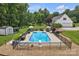 An aerial view of the backyard pool with a diving board, lounge chairs, and a shed in the background at 247 Helton Rd, Cherryville, NC 28021
