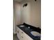 Elegant bathroom featuring a double vanity with dark granite countertops and modern black fixtures at 2560 S Jake Alexander S Blvd, Salisbury, NC 28146