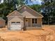 Charming single-Gathering home with a one-car garage and a covered front porch, set against a backdrop of lush green trees at 2560 S Jake Alexander S Blvd, Salisbury, NC 28146