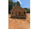 Cozy single-story home with neutral siding, showcasing a welcoming front porch and natural surroundings in a partially cleared lot at 2560 S Jake Alexander S Blvd, Salisbury, NC 28146