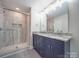 Bathroom features dual vanity, granite countertops, and a tiled walk-in shower at 292 Manchester Rd, Mount Gilead, NC 27306