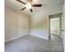 Neutral bedroom features gray carpet, ceiling fan with light, and white closet doors at 292 Manchester Rd, Mount Gilead, NC 27306