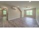 Bonus room features gray vinyl floors, natural light, ceiling fan, and mini split at 292 Manchester Rd, Mount Gilead, NC 27306