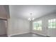 Bright dining area featuring contemporary chandelier lighting and an open view to the exterior yard at 292 Manchester Rd, Mount Gilead, NC 27306