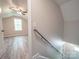 Well-lit hallway with luxury vinyl plank flooring leads to bedrooms and staircase at 292 Manchester Rd, Mount Gilead, NC 27306