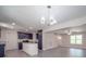 Modern kitchen with a white island, dark cabinets, and stainless steel appliances under stylish lighting at 292 Manchester Rd, Mount Gilead, NC 27306