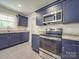 Modern kitchen with dark blue cabinets and stainless steel appliances; oven and microwave combo are visible at 292 Manchester Rd, Mount Gilead, NC 27306