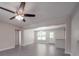 Open-concept living room with new ceiling fan and light gray luxury vinyl floors at 292 Manchester Rd, Mount Gilead, NC 27306