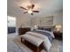 Comfortable main bedroom with ceiling fan, dresser, and a bench at the foot of the bed at 292 Manchester Rd, Mount Gilead, NC 27306
