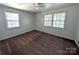 Bedroom featuring neutral walls, two large windows, carpet and a ceiling fan at 309 Fannie Cir, Charlotte, NC 28205